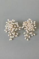 Pair of pearl earrings on a gray background