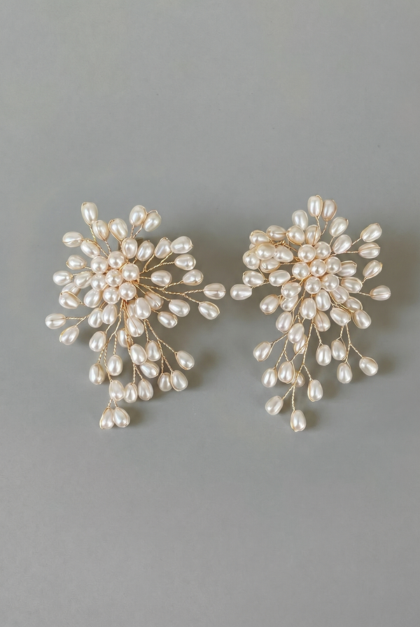 Pair of pearl earrings on a gray background